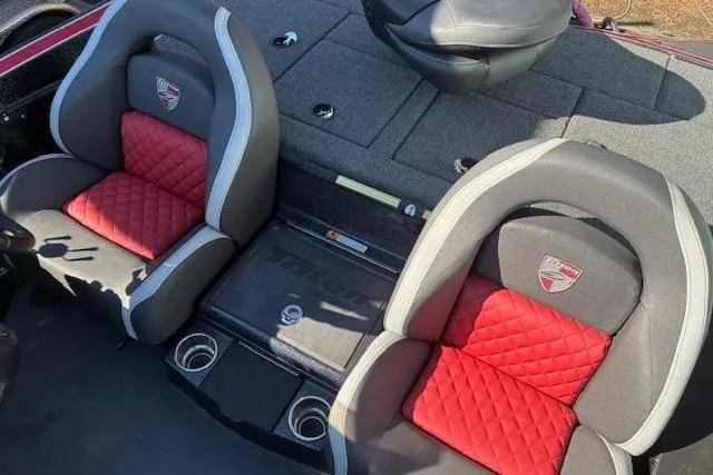 Slide: The Image of 2022 Triton 18 TrX boat interior with red and gray quilted seats. - 14