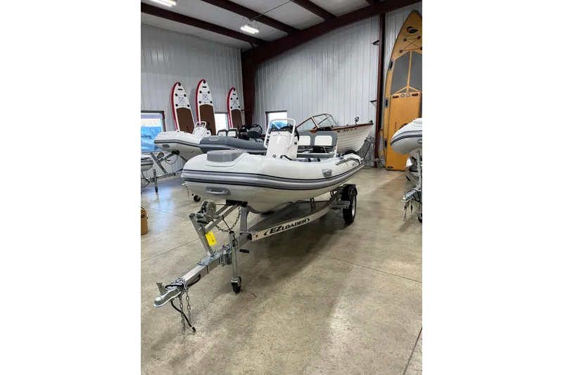 The Image of 2026 Highfield Classic 380 inflatable boat on trailer in showroom. - 0