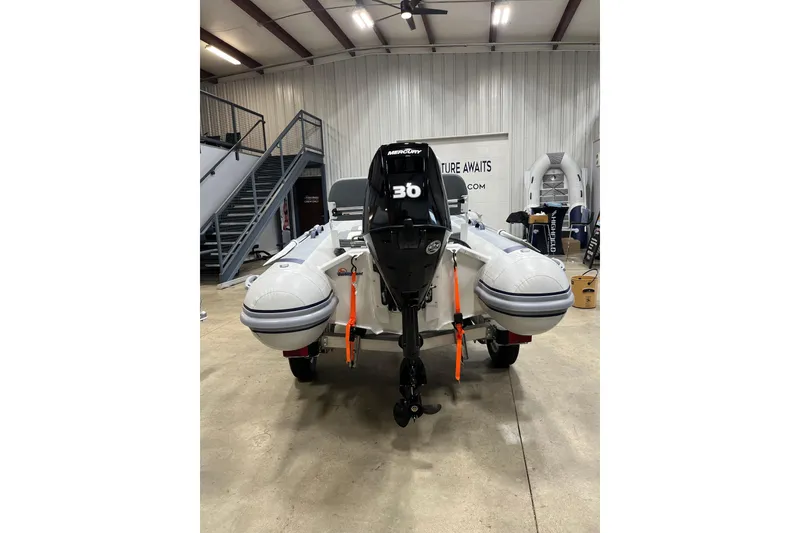 Slide: The Image of 2026 Highfield Classic 380 inflatable boat with Mercury 30 engine in showroom. - 2