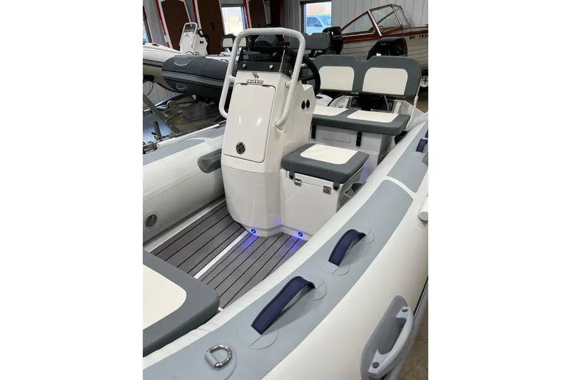 Slide: The Image of 2026 Highfield Classic 380 boat interior with seating and control console. - 5