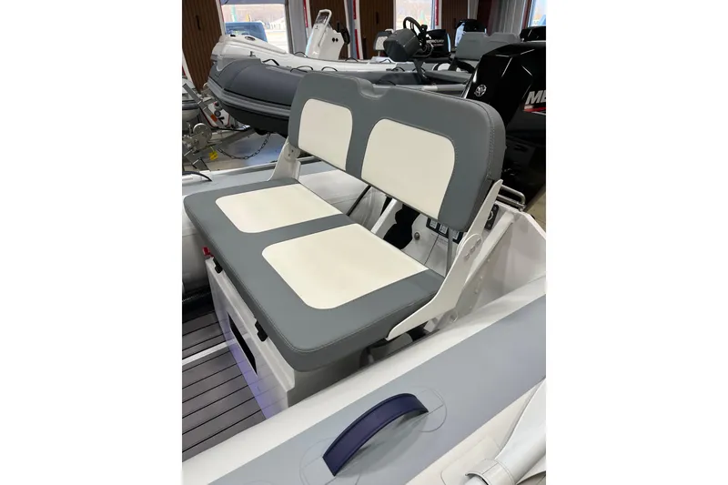 Slide: The Image of 2026 Highfield Classic 380 boat interior with gray and white seating. - 7