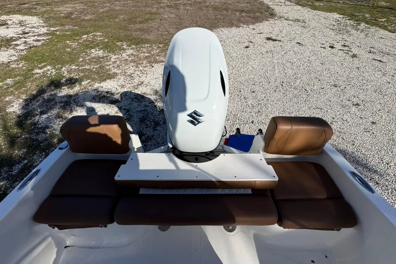 Slide: The Image of 2026 Pioneer 180 Islander boat with brown seating and Suzuki outboard motor. - 13