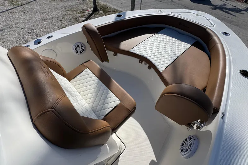 Slide: The Image of 2026 Pioneer 180 Islander boat interior with brown and white cushioned seating. - 4