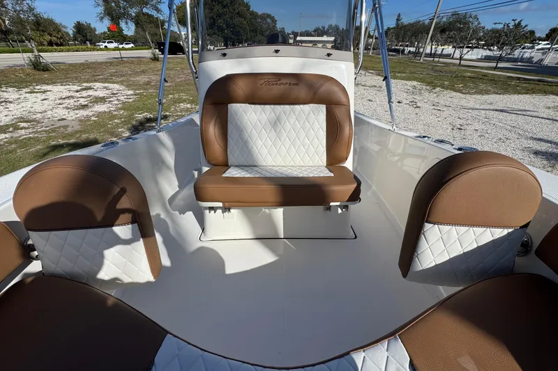 Slide: The Image of 2026 Pioneer 180 Islander boat interior with brown and white seating. - 5