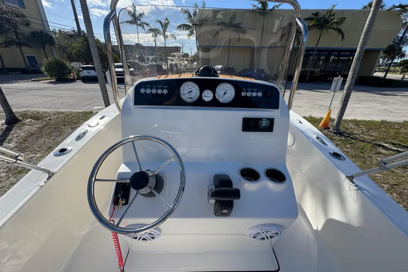 Slide: The Image of 2026 Pioneer 180 Islander boat dashboard with steering wheel and controls. - 8