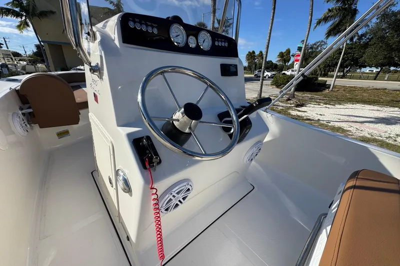 Slide: The Image of 2026 Pioneer 180 Islander boat interior with steering wheel and control panel. - 9