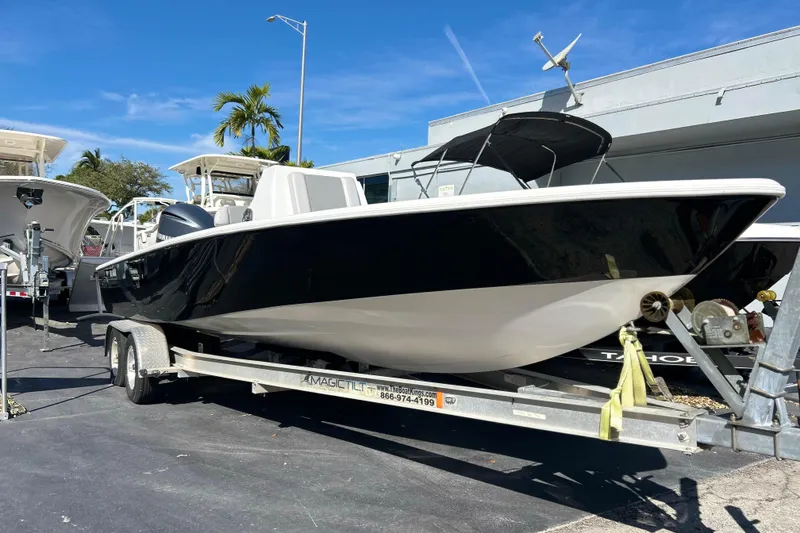 The Image of 2011 Cape Horn 23 Cape Bay boat on trailer, parked outdoors under clear sky. - 1