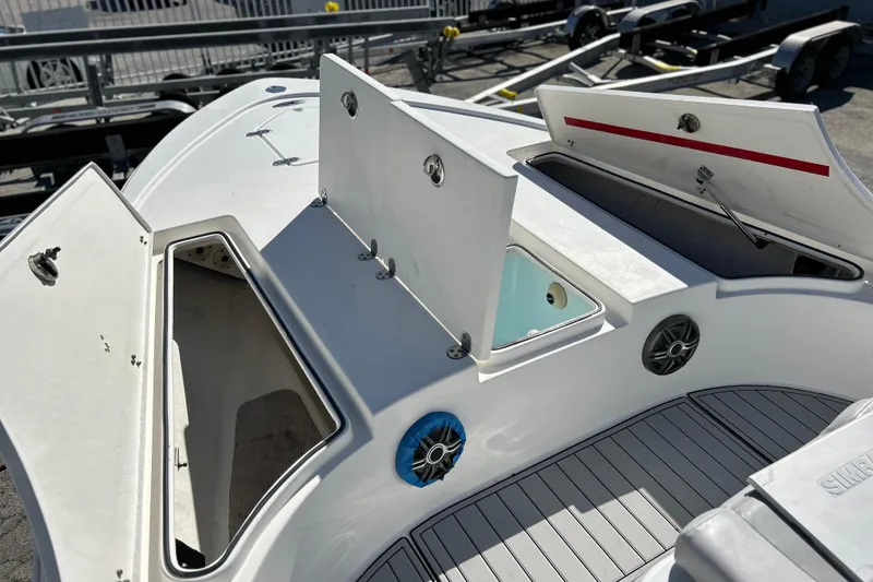 Slide: The Image of 2011 Cape Horn 23 Cape Bay boat with open storage compartments and deck view. - 13