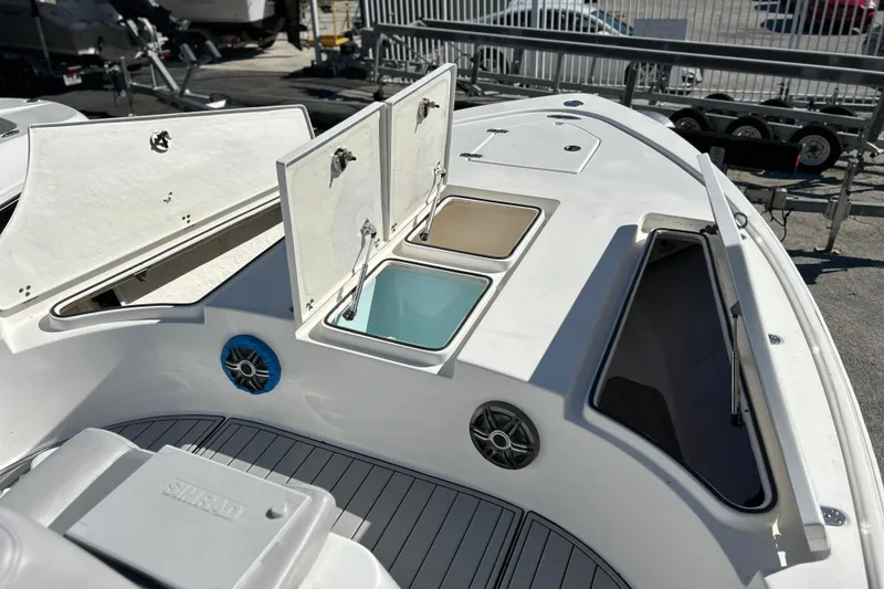 Slide: The Image of 2011 Cape Horn 23 Cape Bay boat with open storage compartments and speakers. - 14