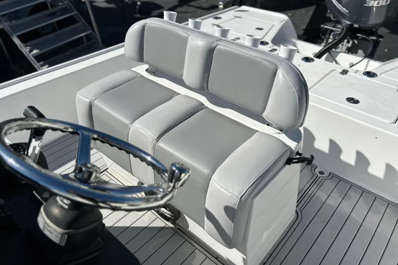 Slide: The Image of 2011 Cape Horn 23 Cape Bay boat interior with steering wheel and cushioned seating. - 7