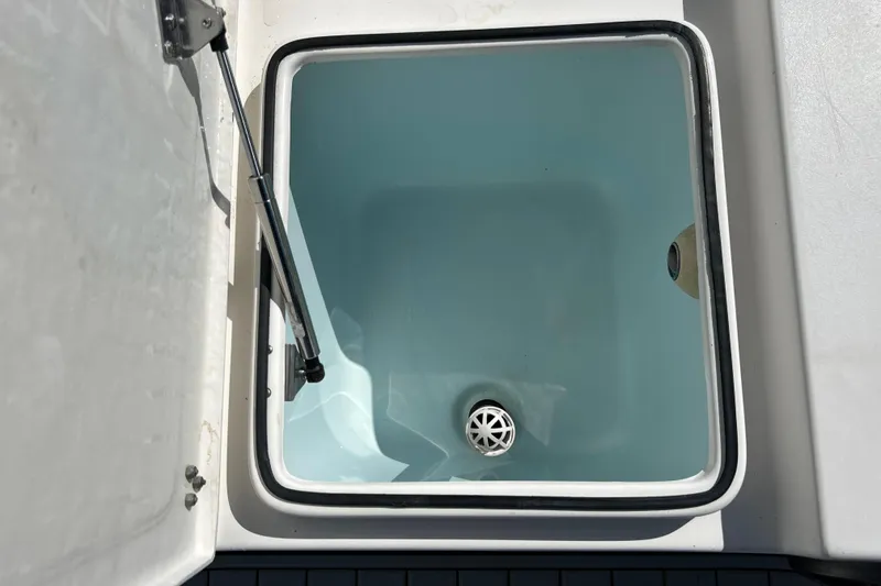 Slide: The Image of Livewell compartment on a 2011 Cape Horn 23 Cape Bay boat, open and empty. - 16