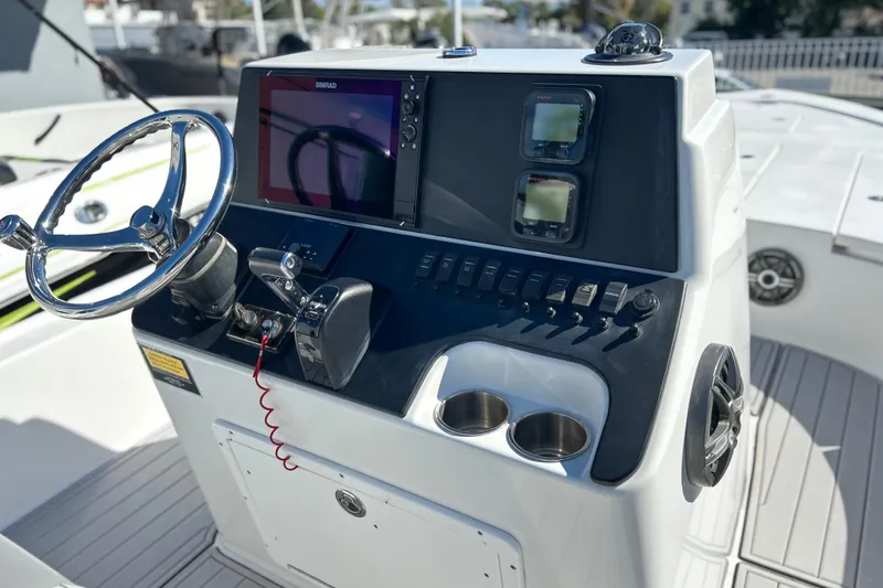 Slide: The Image of 2011 Cape Horn 23 Cape Bay boat console with steering wheel and navigation controls. - 3