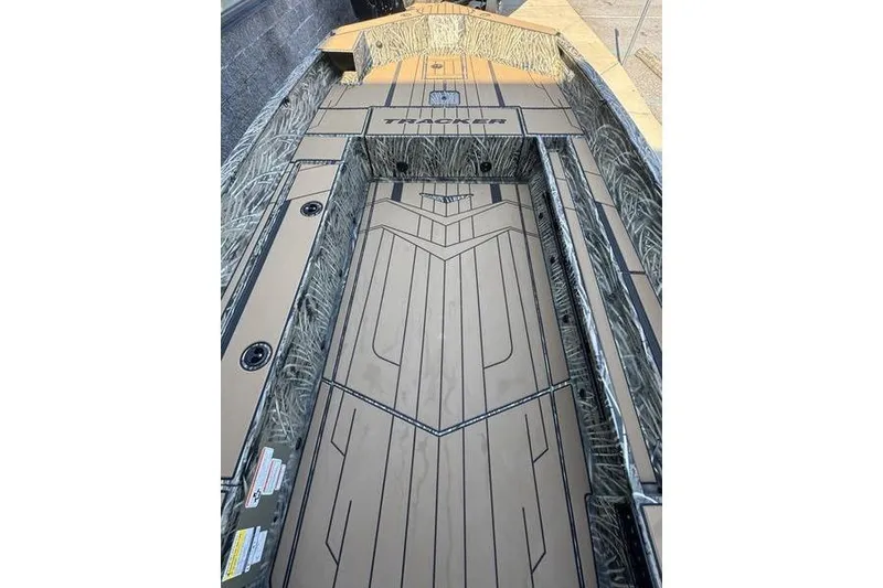Slide: The Image of 2026 Tracker Grizzly 1756 T Marsh boat interior with camo design and spacious deck. - 10
