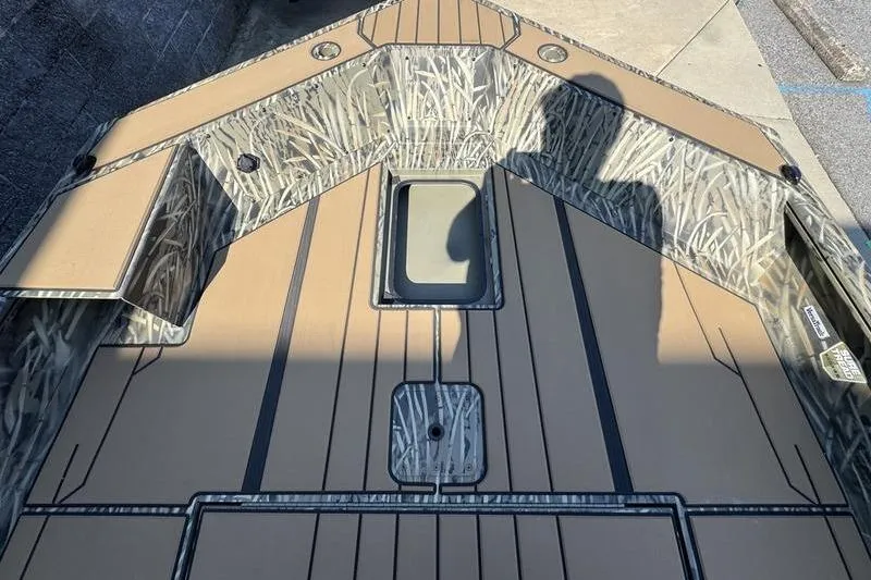 Slide: The Image of 2026 Tracker Grizzly 1756 T Marsh boat interior with camouflage design and storage compartments. - 15