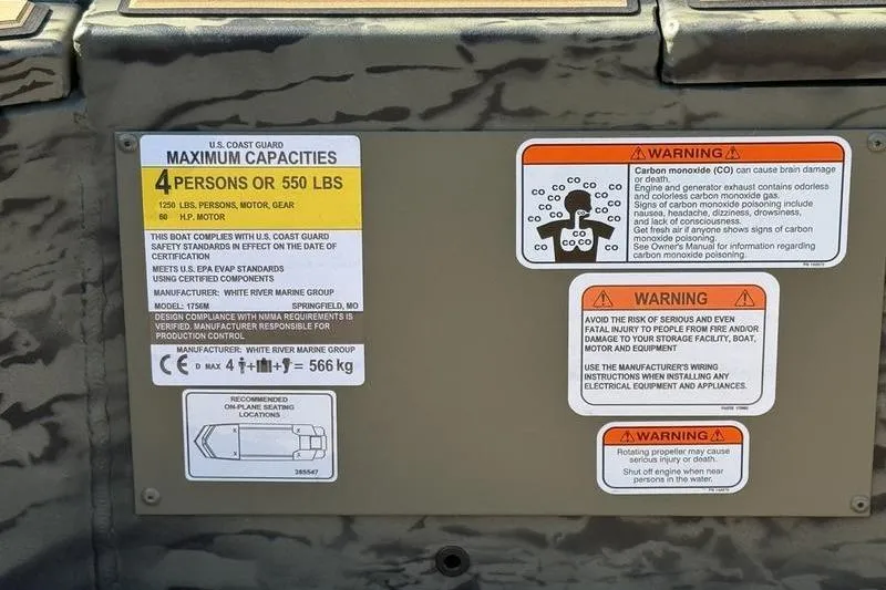 Slide: The Image of 2026 Tracker Grizzly 1756 T Marsh capacity and safety warning labels on boat interior. - 17