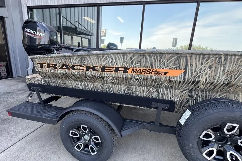 Slide: The Image of 2026 Tracker Grizzly 1756 T Marsh boat with camo design and Mercury outboard motor. - 3