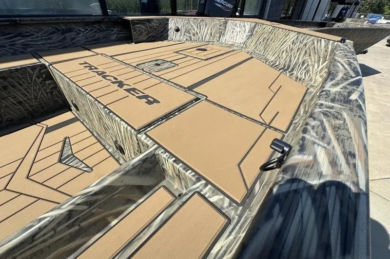Slide: The Image of 2026 Tracker Grizzly 1756 T Marsh boat with camo design and spacious deck layout. - 8