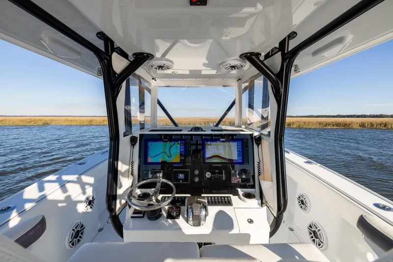 Slide: The Image of 2023 Freeman 34VH boat cockpit with advanced navigation system on open water. - 12
