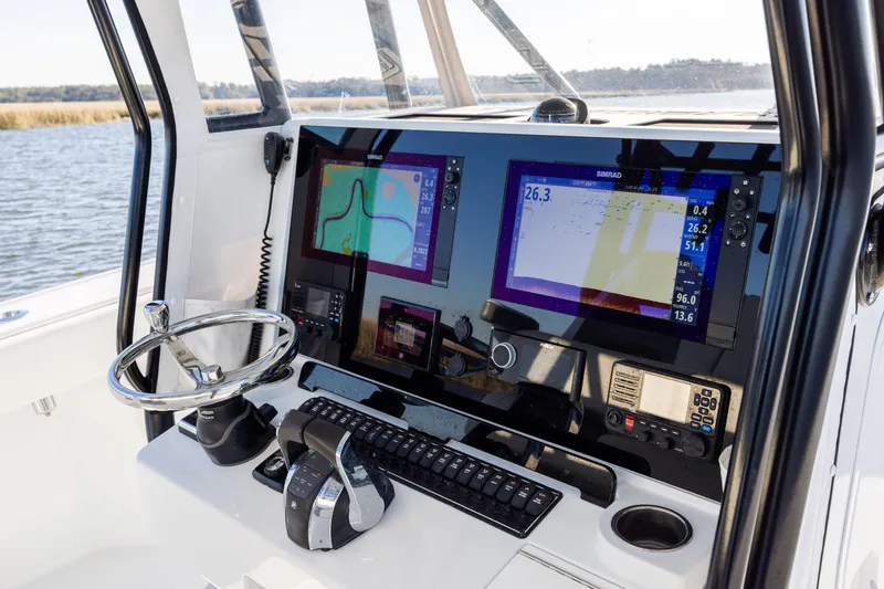 Slide: The Image of 2023 Freeman 34VH boat dashboard with navigation screens and controls. - 13