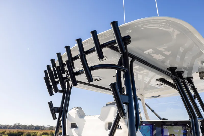 Slide: The Image of 2023 Freeman 34VH boat with rod holders and sleek design under clear blue sky. - 17