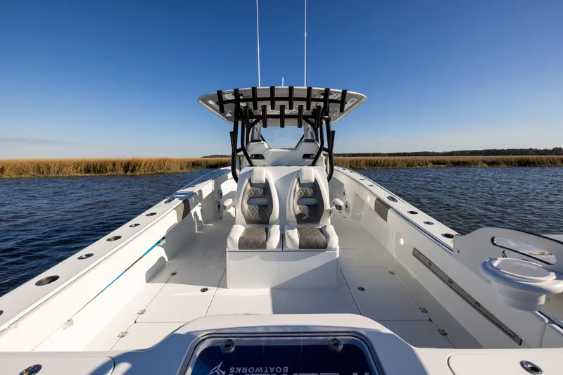 Slide: The Image of 2023 Freeman 34VH boat on water, clear sky, spacious deck, modern design. - 21