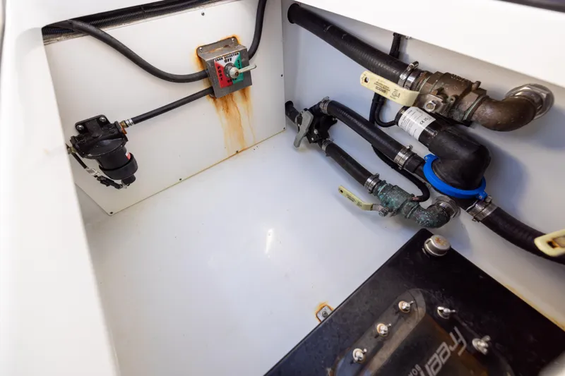 Slide: The Image of Engine compartment of a 2023 Freeman 34VH boat, showing pipes and fittings. - 32