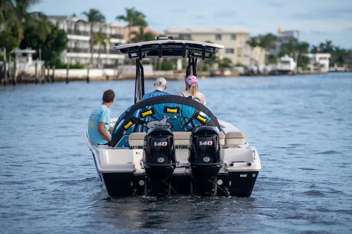 Slide: The Image of 2026 Sea Chaser 24 HFC boat displayed indoors, featuring sleek design and modern amenities. - 2