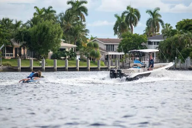 Slide: The Image of 2026 Sea Chaser 24 HFC boat with Suzuki engine displayed indoors. - 3