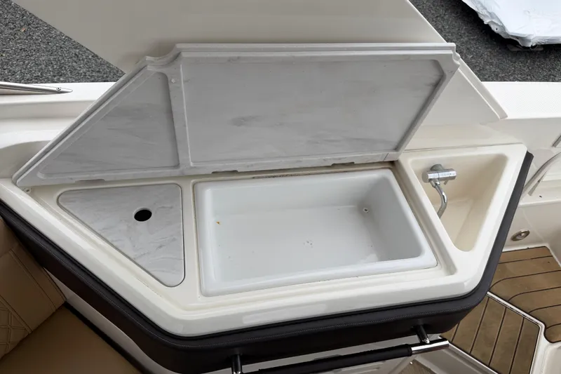 Slide: The Image of 2023 Sea Ray SLX 310 Outboard boat sink and storage compartment. - 11