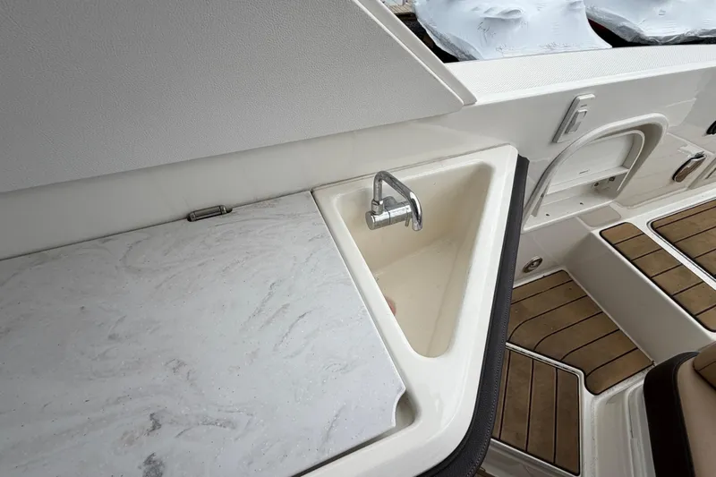 Slide: The Image of 2023 Sea Ray SLX 310 Outboard boat sink and countertop detail. - 12