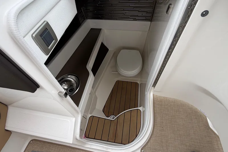 Slide: The Image of 2023 Sea Ray SLX 310 Outboard boat bathroom with wooden flooring and modern fixtures. - 15