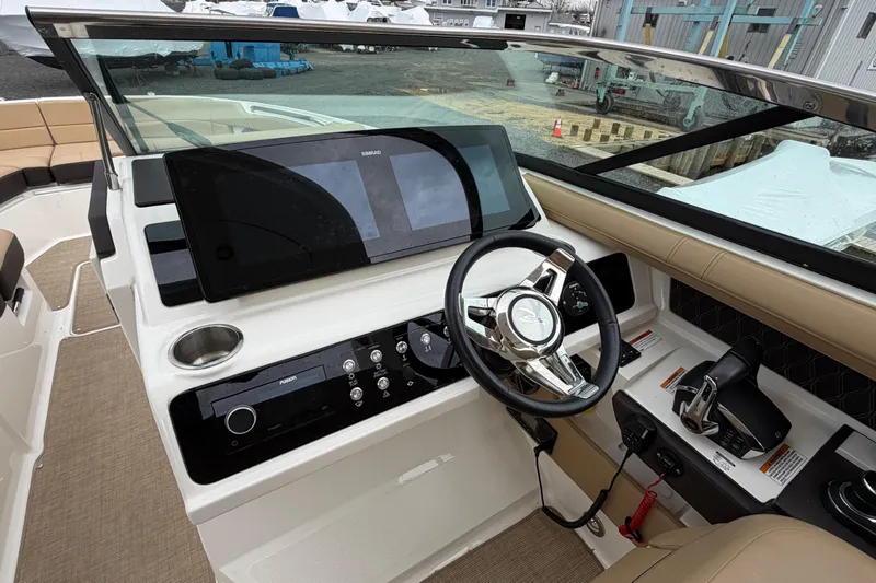 Slide: The Image of 2023 Sea Ray SLX 310 Outboard helm with modern controls and navigation display. - 17