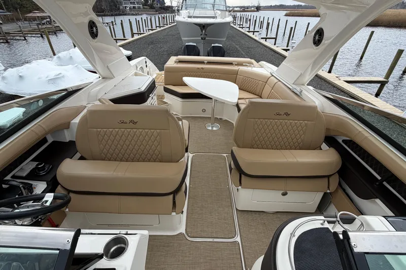 Slide: The Image of 2023 Sea Ray SLX 310 Outboard boat interior with luxurious seating and table. - 20