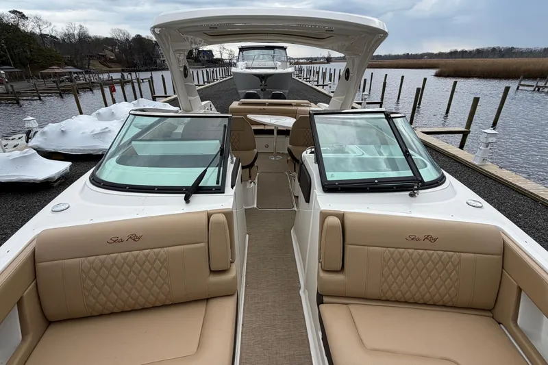 Slide: The Image of 2023 Sea Ray SLX 310 Outboard luxury boat docked, showcasing spacious seating and sleek design. - 21