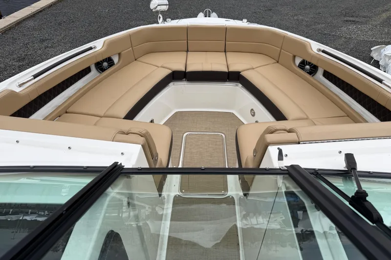Slide: The Image of 2023 Sea Ray SLX 310 Outboard boat with spacious tan seating and sleek design. - 22