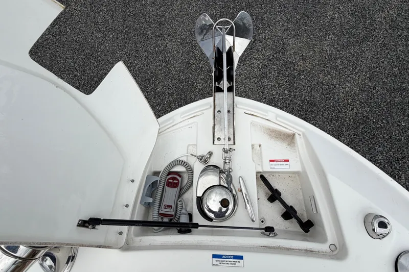 Slide: The Image of 2023 Sea Ray SLX 310 Outboard anchor compartment with controls and accessories. - 23