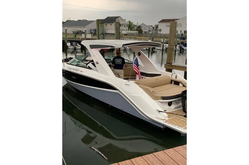 Slide: The Image of 2023 Sea Ray SLX 310 Outboard boat on display under cloudy sky. - 3