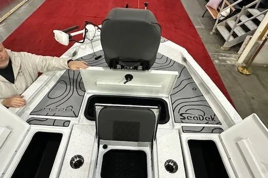 Slide: The Image of 2025 Xpress H22B Bay boat interior with SeaDek flooring and storage compartments. - 12