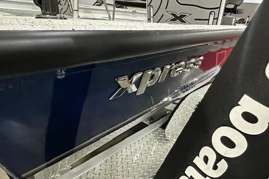 Slide: The Image of 2025 Xpress H22B Bay boat with metallic logo on display. - 9