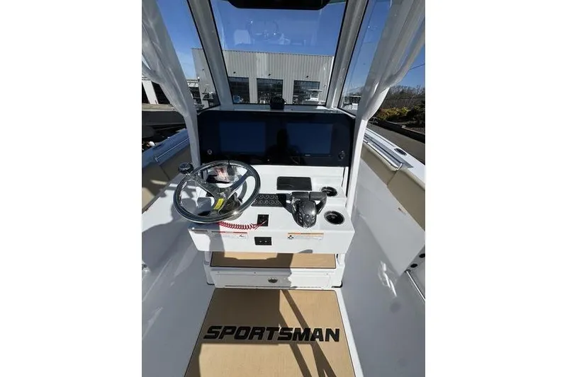Slide: The Image of 2026 Sportsman Open 252 Center Console boat interior with steering wheel and controls. - 12