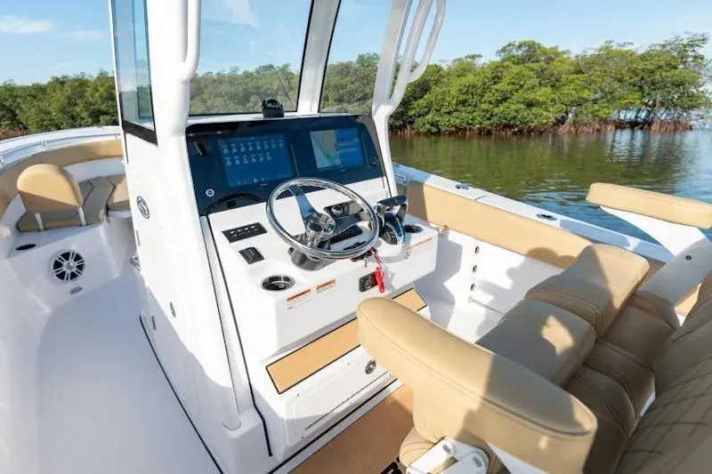 Slide: The Image of 2026 Sportsman Open 252 Center Console boat interior with modern helm and seating. - 13