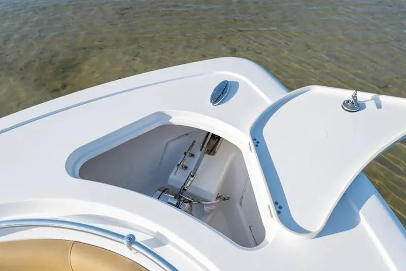 Slide: The Image of 2026 Sportsman Open 252 Center Console boat anchor compartment open on calm water. - 15