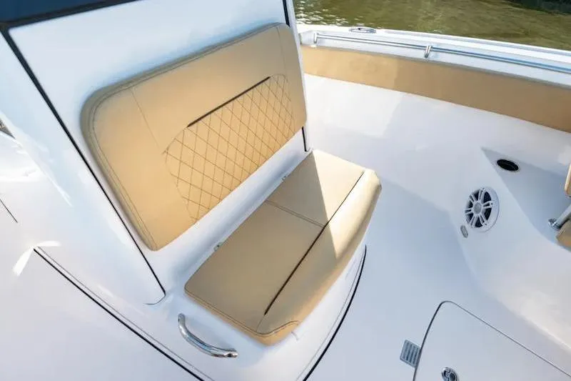 Slide: The Image of 2026 Sportsman Open 252 Center Console boat with tan cushioned seating. - 20