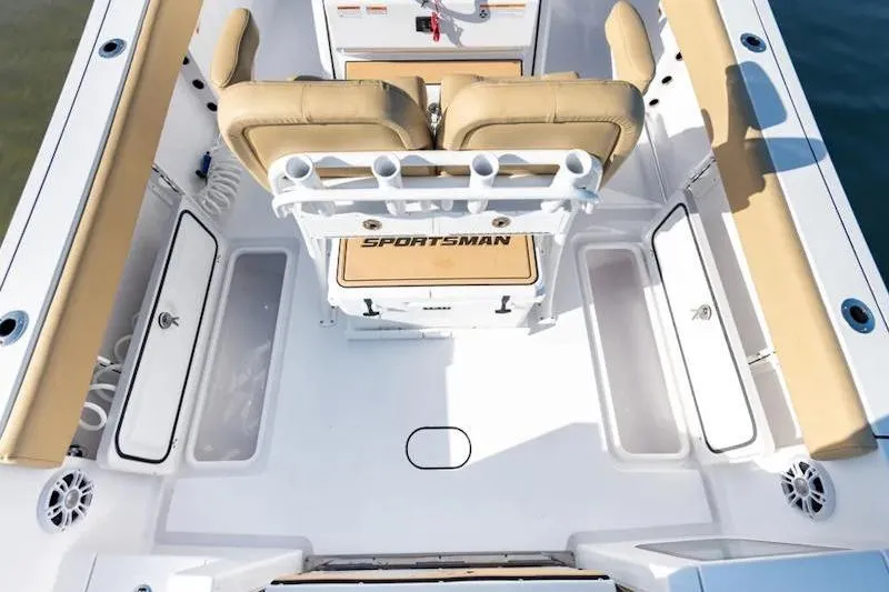 Slide: The Image of 2026 Sportsman Open 252 Center Console boat interior with tan seating and rod holders. - 21