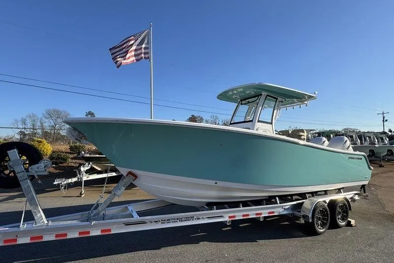 Slide: The Image of 2026 Sportsman Open 252 Center Console boat on trailer, with American flag in background. - 32
