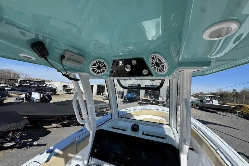Slide: The Image of 2026 Sportsman Open 252 Center Console interior with speakers and controls, docked outdoors. - 33