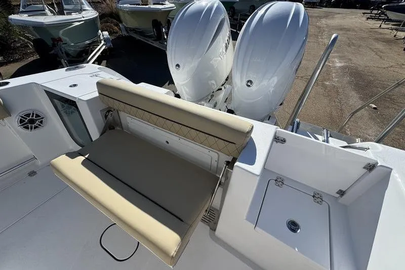 Slide: The Image of 2026 Sportsman Open 252 Center Console boat with dual engines and beige seating. - 34
