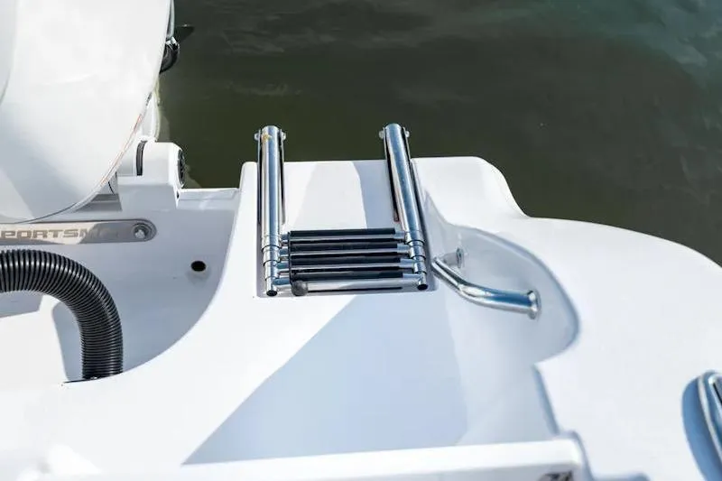 Slide: The Image of 2026 Sportsman Open 252 Center Console boat with stainless steel swim ladder. - 37