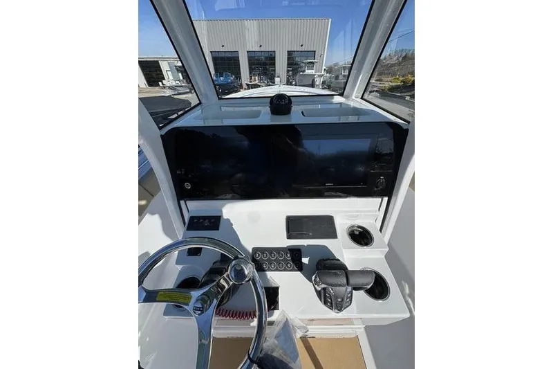Slide: The Image of 2026 Sportsman Open 252 Center Console boat dashboard with steering wheel and controls. - 5