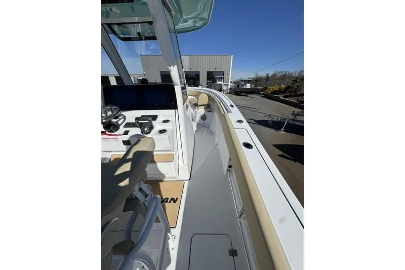 Slide: The Image of 2026 Sportsman Open 252 Center Console boat interior with helm and seating area. - 9